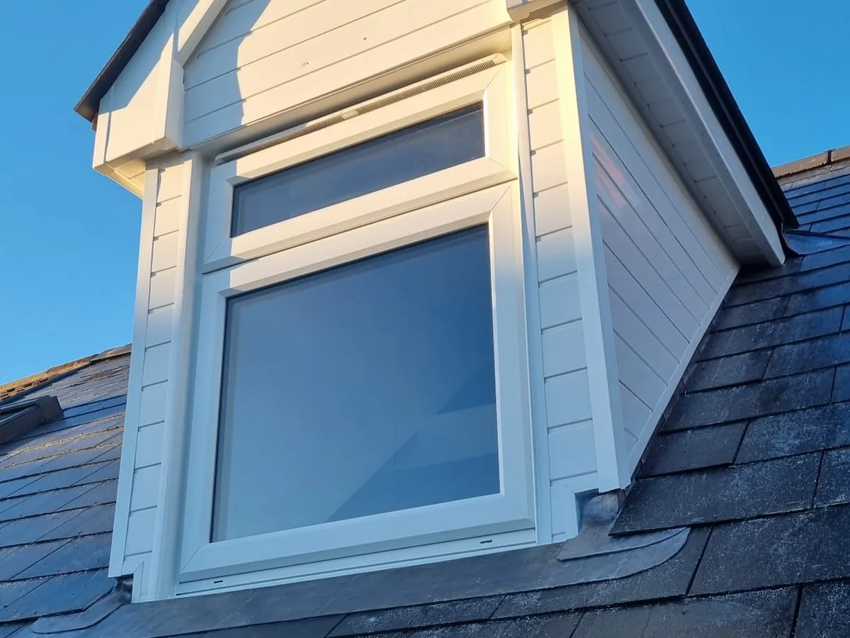 Double-glazed dormer window, complete with new white uPVC cladding.