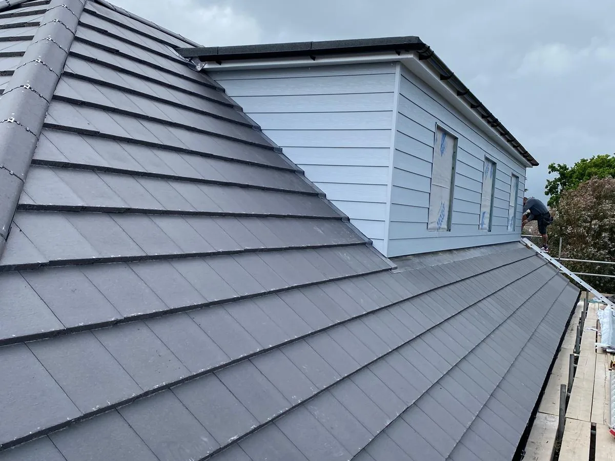 Grey Marley Modern tiled roof, complete with cladding on the dormer and a new two-layer high-performance torch-on mineral felt flat roof.