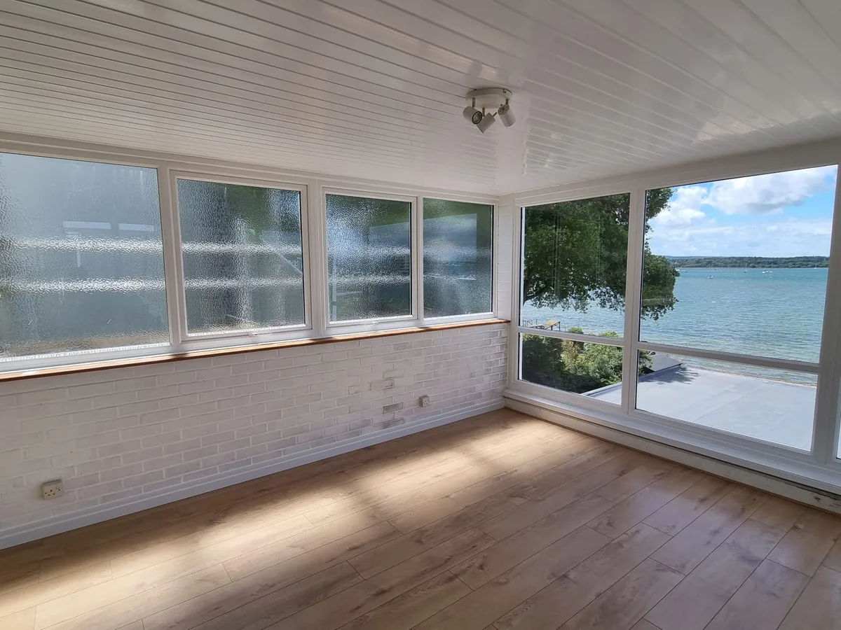 Glazed sunroom overlooking the water